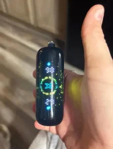 Click to view full screen Illuminated display on a black Geek Bar device held in a hand